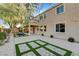 Landscaped backyard with a patio and artificial turf at 7032 N Albatross Attic St, North Las Vegas, NV 89084