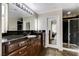 Bathroom with dark granite countertop and walk-in shower at 7032 N Albatross Attic St, North Las Vegas, NV 89084