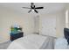 Bedroom with ceiling fan, double doors, and TV at 7061 Stockton Dunes St, North Las Vegas, NV 89084