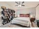 Bright bedroom featuring a ceiling fan, a book case, and a comfortable bed with pink pillows at 7277 Abbeyville Dr, Las Vegas, NV 89119