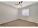 Well-lit bedroom with ceiling fan and carpet at 7300 Mountain Thicket St, Las Vegas, NV 89131