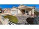 Single-story house with a two-car garage and rock landscaping at 7300 Mountain Thicket St, Las Vegas, NV 89131