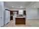 Modern kitchen with granite island, dark cabinets and tile floor at 7640 Houston Peak St, Las Vegas, NV 89166