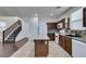 Modern kitchen with granite island, dark cabinets and tile floor at 7640 Houston Peak St, Las Vegas, NV 89166