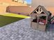 Backyard patio with playhouse and artificial turf at 10766 Wild Parsley Ave, Las Vegas, NV 89129