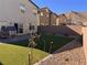 Landscaped backyard with artificial turf and paver patio at 10766 Wild Parsley Ave, Las Vegas, NV 89129