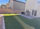 Artificial turf backyard with playhouse and patio at 10766 Wild Parsley Ave, Las Vegas, NV 89129