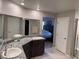 Double vanity bathroom with granite countertops and walk in shower at 10766 Wild Parsley Ave, Las Vegas, NV 89129