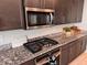 Modern kitchen with gas cooktop and stainless steel microwave at 10766 Wild Parsley Ave, Las Vegas, NV 89129