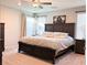 Main bedroom with a large bed and stylish decor at 10766 Wild Parsley Ave, Las Vegas, NV 89129