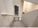 Stairs with grey carpet, leading to an upper level with a bathroom at 10766 Wild Parsley Ave, Las Vegas, NV 89129