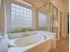 Bathroom featuring a soaking tub, shower, and large window at 10840 Villa Torre St, Las Vegas, NV 89141