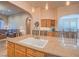 Kitchen island with sink, granite countertops, and views to Gathering room at 10840 Villa Torre St, Las Vegas, NV 89141