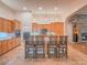 Spacious kitchen with island, stainless steel appliances, and light wood cabinets at 10840 Villa Torre St, Las Vegas, NV 89141