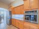 Kitchen with stainless steel appliances and light wood cabinets at 10840 Villa Torre St, Las Vegas, NV 89141