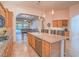 Island kitchen with breakfast bar, stainless steel appliances, and wine rack at 10840 Villa Torre St, Las Vegas, NV 89141