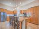 Bright kitchen features stainless steel appliances and an island with seating at 10840 Villa Torre St, Las Vegas, NV 89141