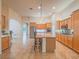 Open kitchen boasts an island, ample cabinetry, and views into Gathering room at 10840 Villa Torre St, Las Vegas, NV 89141