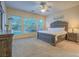 Main bedroom with large windows, pool view, and a luxurious bed at 10840 Villa Torre St, Las Vegas, NV 89141