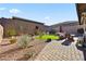 Landscaped backyard with artificial turf, patio, and seating area at 1170 N Water St, Henderson, NV 89011