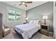 Cozy bedroom with window shutters and a ceiling fan at 1170 N Water St, Henderson, NV 89011