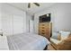 Bedroom with a dresser, chair, and ceiling fan at 1170 N Water St, Henderson, NV 89011