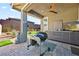 Outdoor kitchen with built-in grill, cabinets, and a ceiling fan at 1170 N Water St, Henderson, NV 89011