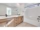 Modern bathroom with double vanity, soaking tub, and walk-in shower at 11935 Glide Reflection Ave, Las Vegas, NV 89138