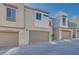 Modern townhome exterior with attached garage and stone accents at 11935 Glide Reflection Ave, Las Vegas, NV 89138