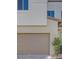 Attached garage with taupe-colored door and stone facade at 11935 Glide Reflection Ave, Las Vegas, NV 89138