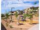 Community playground with climbing structure and shaded seating area surrounded by modern homes and lush landscaping at 11935 Glide Reflection Ave, Las Vegas, NV 89138