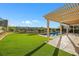 Inviting backyard oasis features a sparkling pool, lush grass, and pergola at 1343 Panini Dr, Henderson, NV 89052