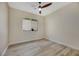 Well-lit bedroom with ceiling fan and wood-look flooring at 1343 Panini Dr, Henderson, NV 89052