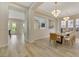 Bright dining room with a large wooden table and modern light fixture at 1343 Panini Dr, Henderson, NV 89052