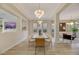 Elegant dining room featuring a long wooden table and contemporary chandelier at 1343 Panini Dr, Henderson, NV 89052