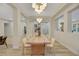 Modern farmhouse dining room with a long wooden table and statement lighting at 1343 Panini Dr, Henderson, NV 89052