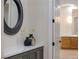 Elegant entryway with gray cabinets, marble countertop and a large circular mirror at 1343 Panini Dr, Henderson, NV 89052