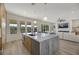 Open concept kitchen with marble island and stainless steel appliances, overlooking living room at 1343 Panini Dr, Henderson, NV 89052