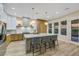 Modern kitchen with light wood cabinets, marble island, and stainless steel appliances at 1343 Panini Dr, Henderson, NV 89052