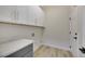 Laundry room with white cabinets and gray countertop at 1343 Panini Dr, Henderson, NV 89052