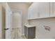 Bright laundry room with white cabinets and gray base cabinets at 1343 Panini Dr, Henderson, NV 89052