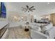 Living area with sectional sofa, fireplace, and views into dining room and kitchen at 1343 Panini Dr, Henderson, NV 89052