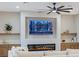 Living room featuring a built-in fireplace and large TV at 1343 Panini Dr, Henderson, NV 89052