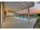 Evening view of a refreshing pool and pergola-covered patio at 1343 Panini Dr, Henderson, NV 89052