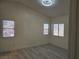 Bright bedroom with wood-look floors and three windows at 1732 Monte Alban Dr, North Las Vegas, NV 89031