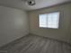 Simple bedroom with wood-look floors and one window at 1732 Monte Alban Dr, North Las Vegas, NV 89031