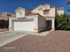 Two-story house with a two-car garage and gravel driveway at 1732 Monte Alban Dr, North Las Vegas, NV 89031