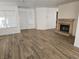 Bright living room featuring wood-look floors and fireplace at 1732 Monte Alban Dr, North Las Vegas, NV 89031