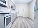 Modern kitchen with gray cabinets and white appliances at 1972 H St, Las Vegas, NV 89106