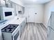 Modern kitchen with gray cabinets and white appliances at 1972 H St, Las Vegas, NV 89106